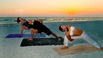 Yoga on the beach Side angle with bind